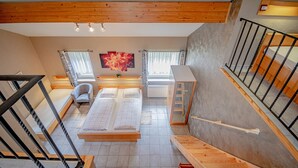 A bedroom with a large bed, a chair, a desk, and a window. - Hotel Ulftaler Schenke (Burg-Reuland)