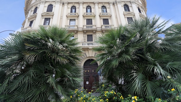 A classical building with a symmetrical facade, multiple windows, and a central entrance. - Piazza Bovio 22 (Naples)
