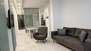 Deluxe Studio Suite, Ground Floor | Living area | 55-inch Smart TV with satellite channels