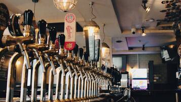 A bar with multiple taps and a beer tap labeled 'Budweiser.'