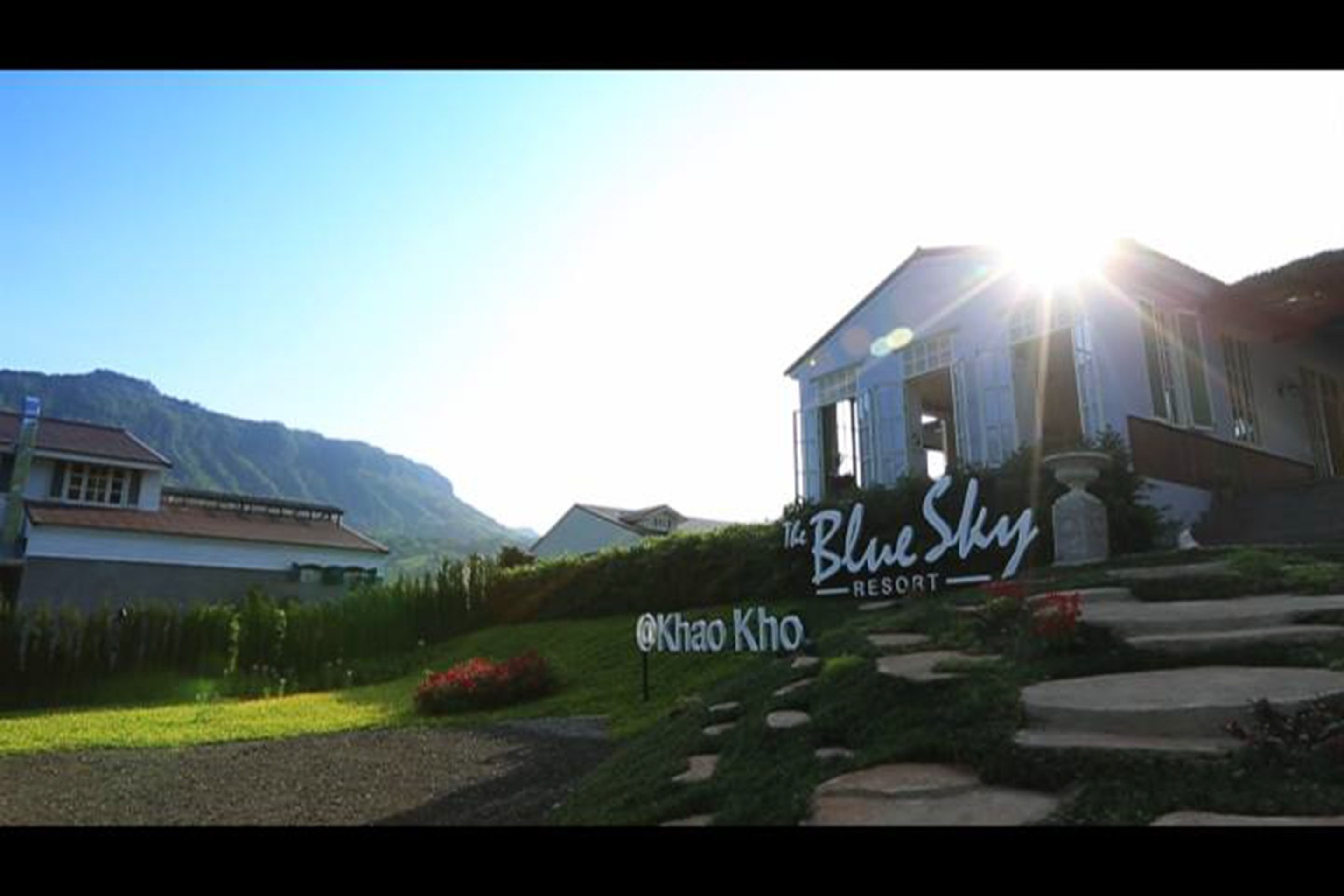 A resort named 'The Blue Sky' with a sign indicating 'Khao Kho'.