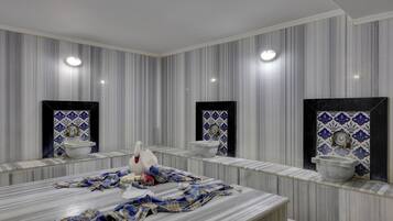 Bathroom features a marble vanity, large mirror, and two sinks with decorative tiles.