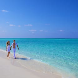 On the beach, white sand, sun loungers, beach towels