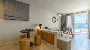 A modern living area with a wooden island, a round table, and a sofa.