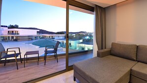 A modern living room with a large sliding glass door leading to an outdoor terrace. - Jasmin Elite Residence & SPA (Bodrum)