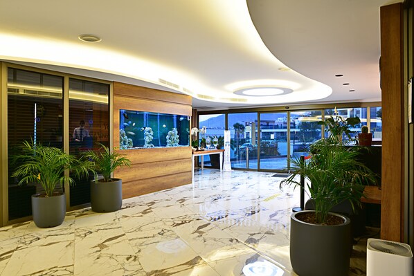 A modern lobby with marble flooring, large windows, and potted plants. - Jasmin Elite Residence & SPA (Bodrum)