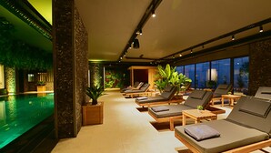 A spa area with a pool, sun loungers, and potted plants. - Jasmin Elite Residence & SPA (Bodrum)