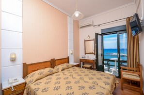 Standard Twin Room (Port View) | Down comforters, desk, iron/ironing board, free WiFi - Coronis Hotel (Naxos)