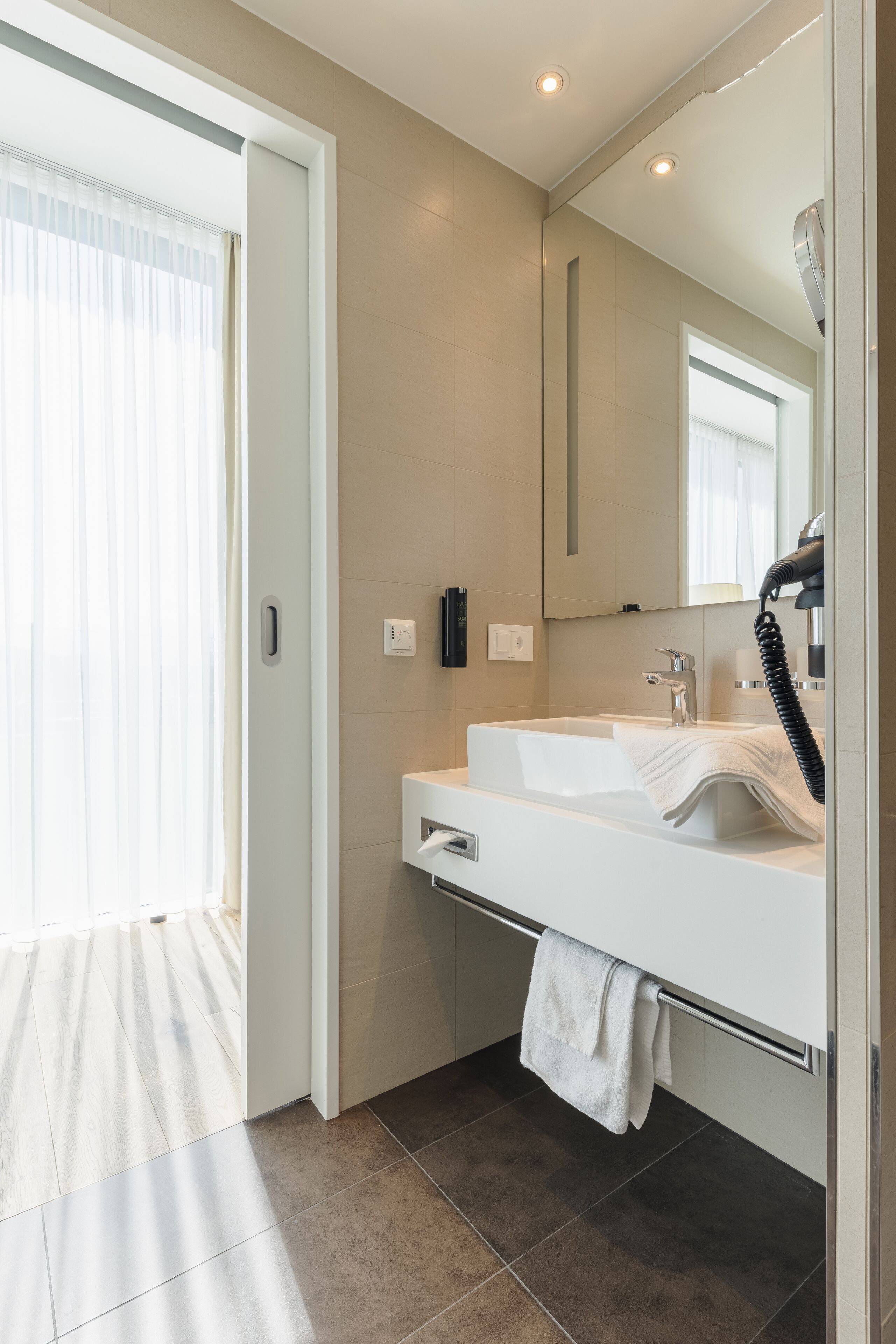 shower, rainfall showerhead, hair dryer, towels