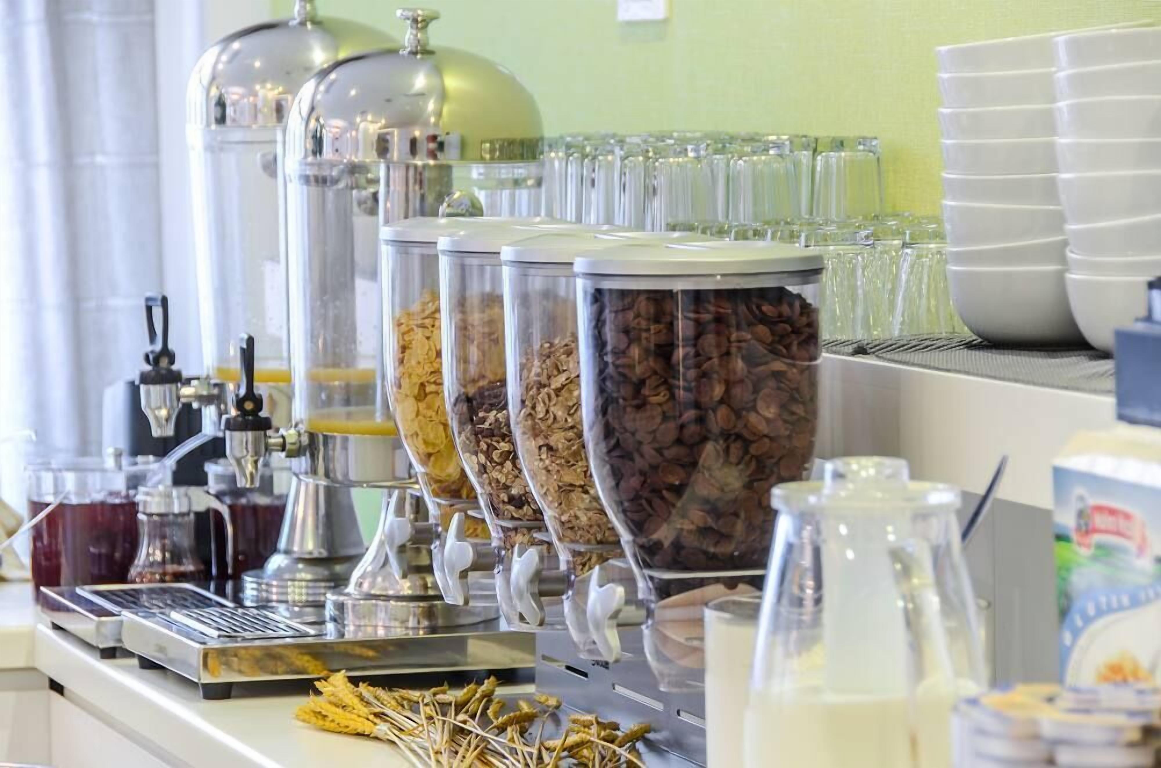 A coffee station with multiple dispensers and containers of coffee beans.