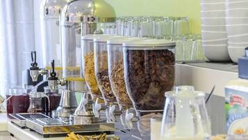 A coffee station with multiple dispensers and containers of coffee beans.