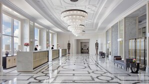 A spacious hotel lobby with a marble floor, large windows, a reception desk, and a chandelier. - The Langham, Haikou (Haikou)