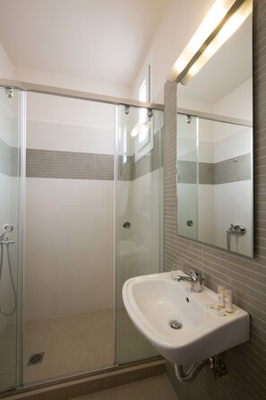 Shower, designer toiletries, hair dryer, bathrobes