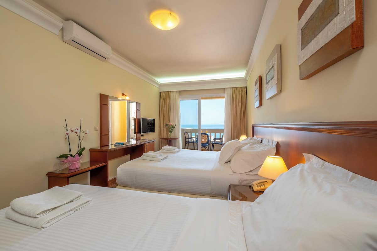 superior triple room, sea view | 1 bedroom, in-room safe, blackout curtains, soundproofing