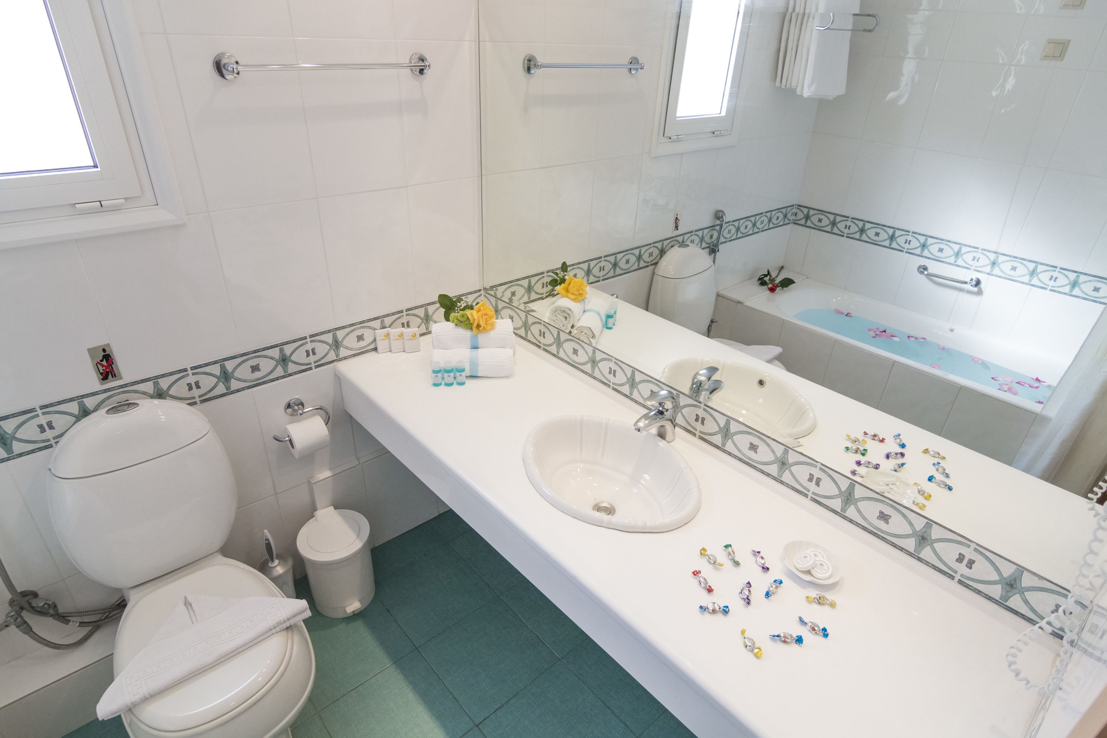 designer toiletries, hair dryer, towels