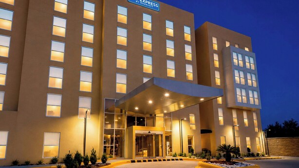 A hotel with a modern design, featuring a prominent entrance with a covered walkway, multiple windows, and a sign indicating it is a Marriott property. - City Express by Marriott Piedras Negras (Piedras Negras)