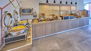 A buffet setup with various food items and utensils, a microwave, and a coffee station. - City Express by Marriott Ciudad de México Aeropuerto (Mexico City)
