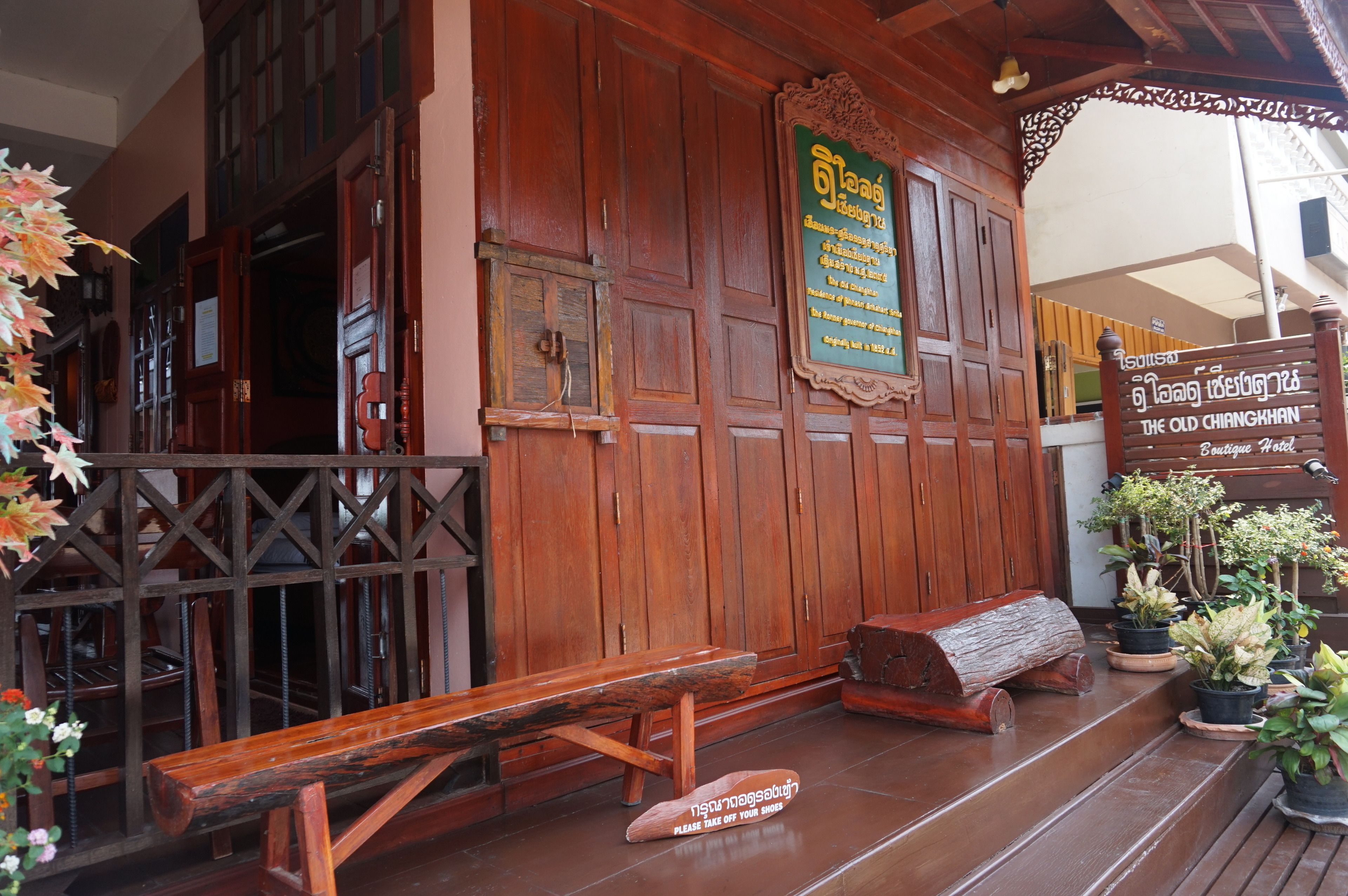 A wooden building with a sign reading "The Old Chiang Khan."