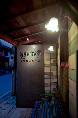 Un callejón estrecho con un banco de madera y un muro con bloques de colores.