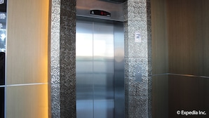 An elevator with a digital display and metallic walls. - Sun Plaza Subic (Olongapo)