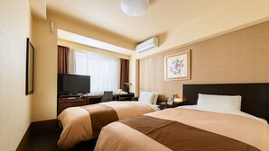 A hotel room with two beds, a desk with a computer, a television, and a window with curtains. - Hotel Sealuck Pal Kofu (Kofu)
