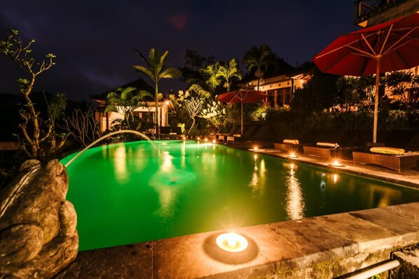 Una piscina al aire libre, tumbonas