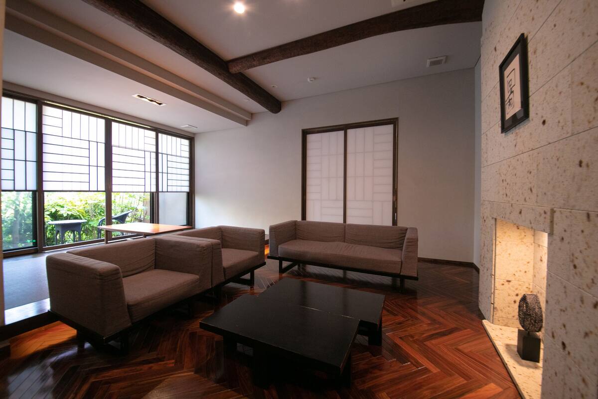 A modern living room with two sofas, a coffee table, and a fireplace.