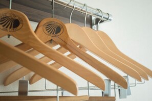Wooden hangers on a metal rack.