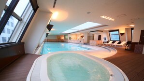 A modern indoor pool area with a hot tub, wooden flooring, and large windows providing natural light. - Hotel Allamanda Aoyama Tokyo (Tokyo)