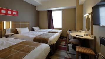A hotel room with three beds, a desk, a chair, a TV, and a window with curtains.