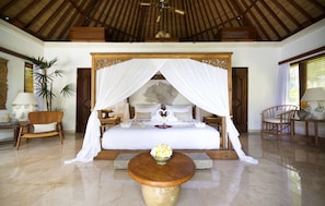 A spacious bedroom with a large bed, a wooden ceiling, and a decorative canopy. - Planta Luxury Boutique Resort (Canggu)