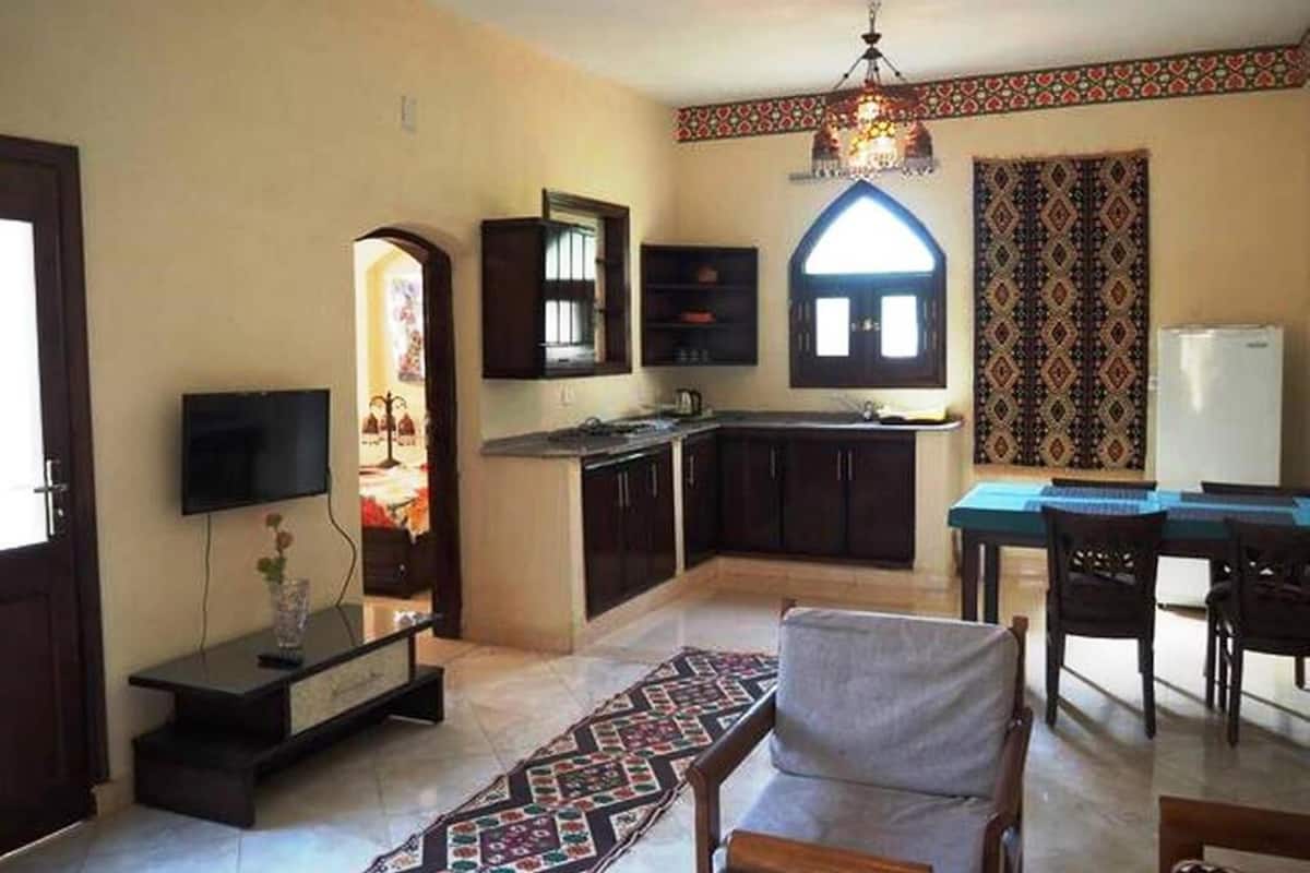 A compact living space with a kitchen, dining area, and a TV.