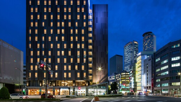 A high-rise hotel with a modern facade, multiple floors, and illuminated windows. - Daiwa Roynet Hotel Nagoya Taiko dori Side (Nagoya)