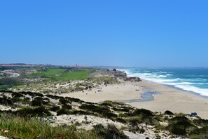 Beach nearby, white sand, beach umbrellas, beach towels