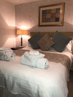 Premium bedding, desk, laptop workspace, iron/ironing board