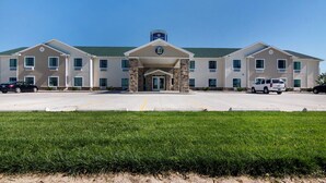 A two-story building with a central entrance, multiple windows, and a parking lot in front. - Cobblestone Inn & Suites - Lakin (Lakin)