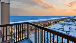 A balcony with a view of the beach and ocean during sunset. - Hampton Inn & Suites Carolina Beach Oceanfront (Carolina Beach)