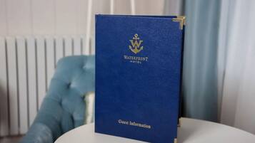 A blue guest information booklet for the Waterfront Hotel.