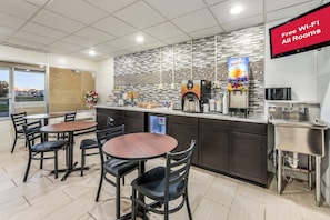 Ein Café-Interieur mit Theke, Sitzbereich und einem Schild, das kostenloses WLAN anzeigt.