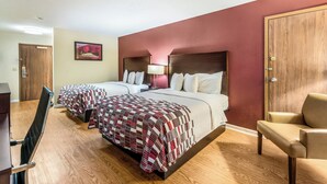 A hotel room with two beds, a desk, a chair, and a door. - Red Roof Inn & Suites Wapakoneta (Wapakoneta)