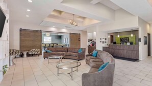 A spacious lobby with a reception desk, sofas, and a coffee table. - Best Western Plus Pflugerville (Pflugerville)