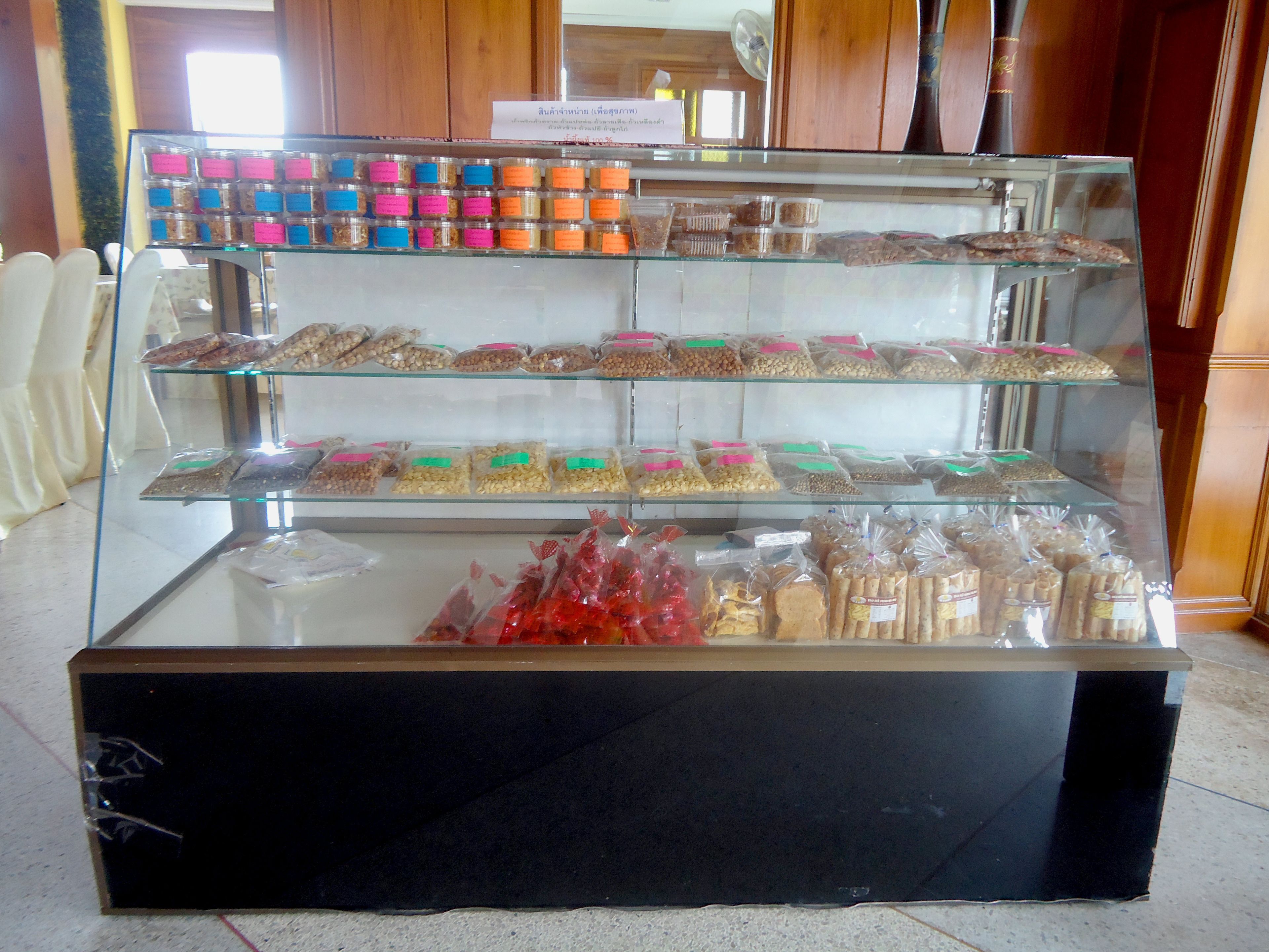 A display case with various packaged snacks and food items.