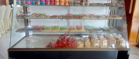 A display case with various packaged snacks and food items.