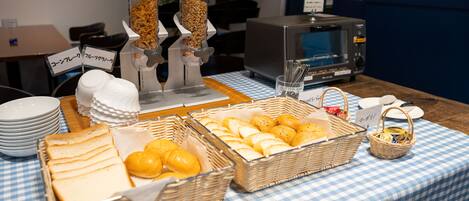 A buffet table with various food items and condiments.