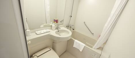 A small, clean bathroom with a toilet, sink, and shower.