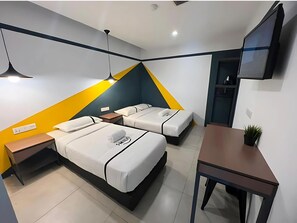 A modern hotel room with two beds, a desk, a TV, and a small plant. - Smile Hotel Cheras Sri Permaisuri (Kuala Lumpur)