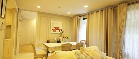 A dining area with a table, chairs, and a sofa.