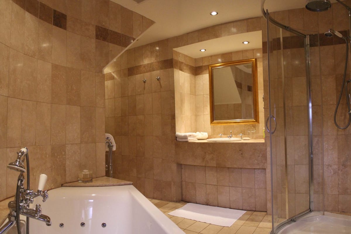 suite | bathroom | rainfall showerhead, designer toiletries, hair dryer, bathrobes