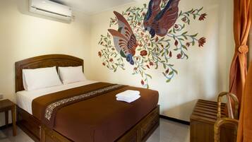 A hotel room with a wooden bed, a decorative wall mural, and a wooden chair.