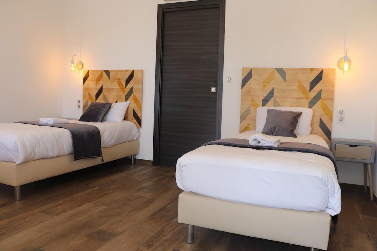 family room, multiple beds | 3 bedrooms, desk, soundproofing, iron/ironing board